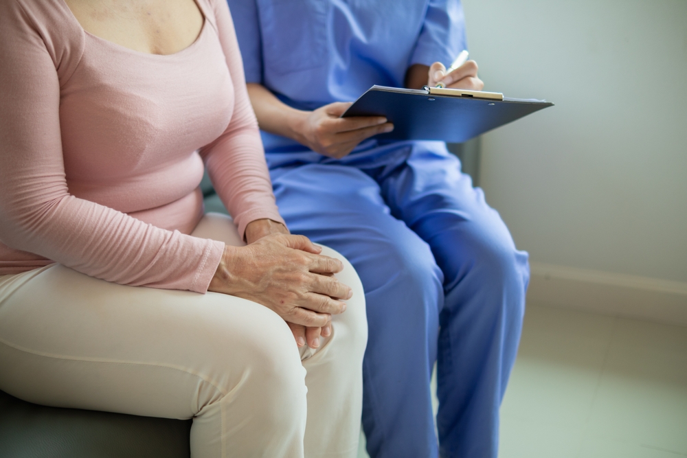 woman sitting next to doctor.