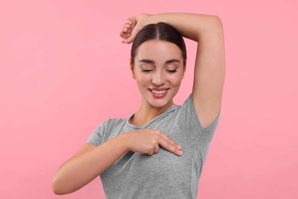 woman giving herself breast exam.